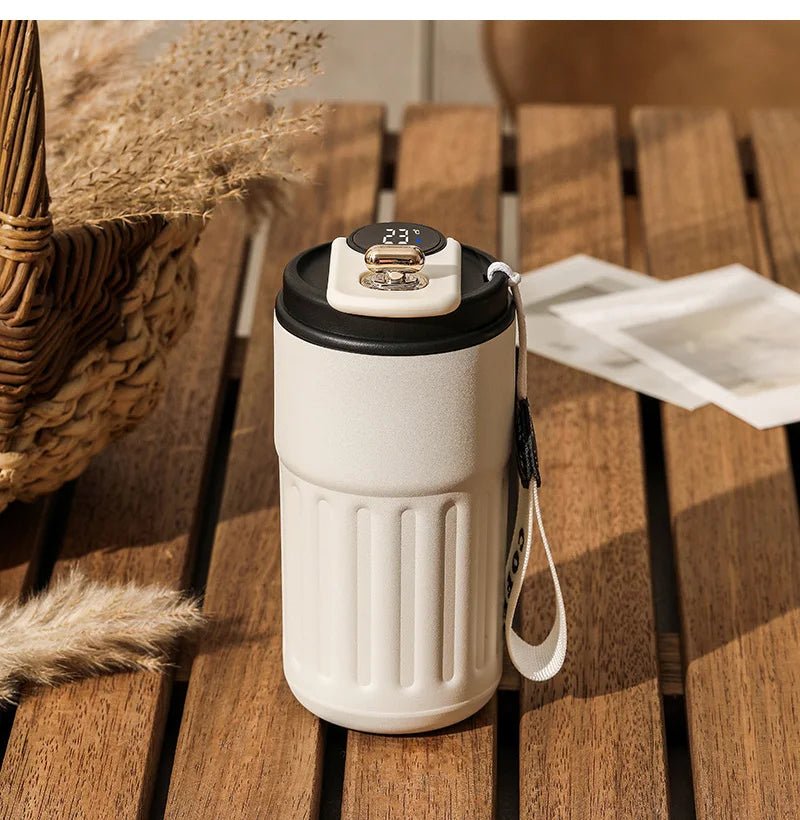 White tumbler  with digital display on a wooden surface