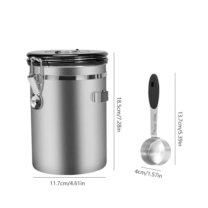 Stainless steel canister with measuring spoon and dimensions on a white background
