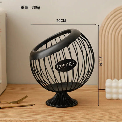 Black wire coffee grinder with 'COFFEE' label on a wooden surface, showing measurements.
