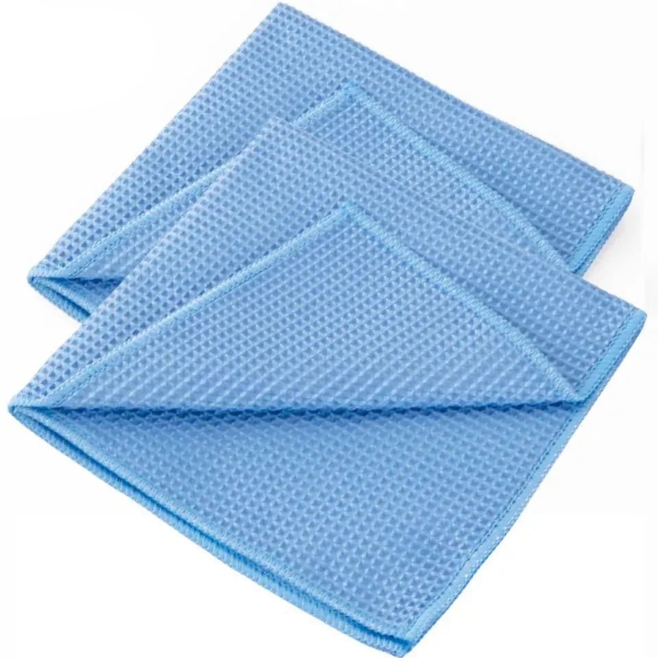 Set of blue waffle-textured cloths on a white background