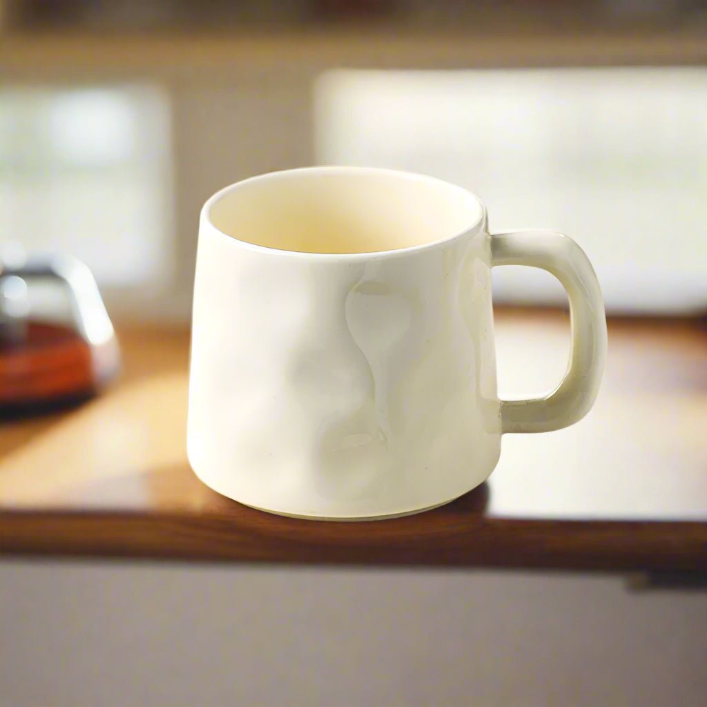 White mug on a wooden surface with a blurred background
