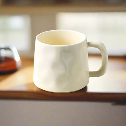 White mug on a wooden surface with a blurred background