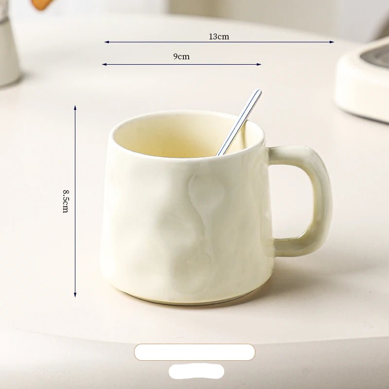 White ceramic mug with dimensions labeled on a light background