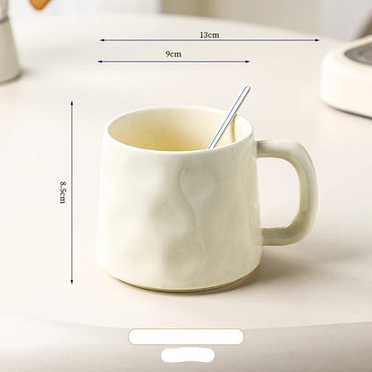 White ceramic mug with dimensions labeled on a light background
