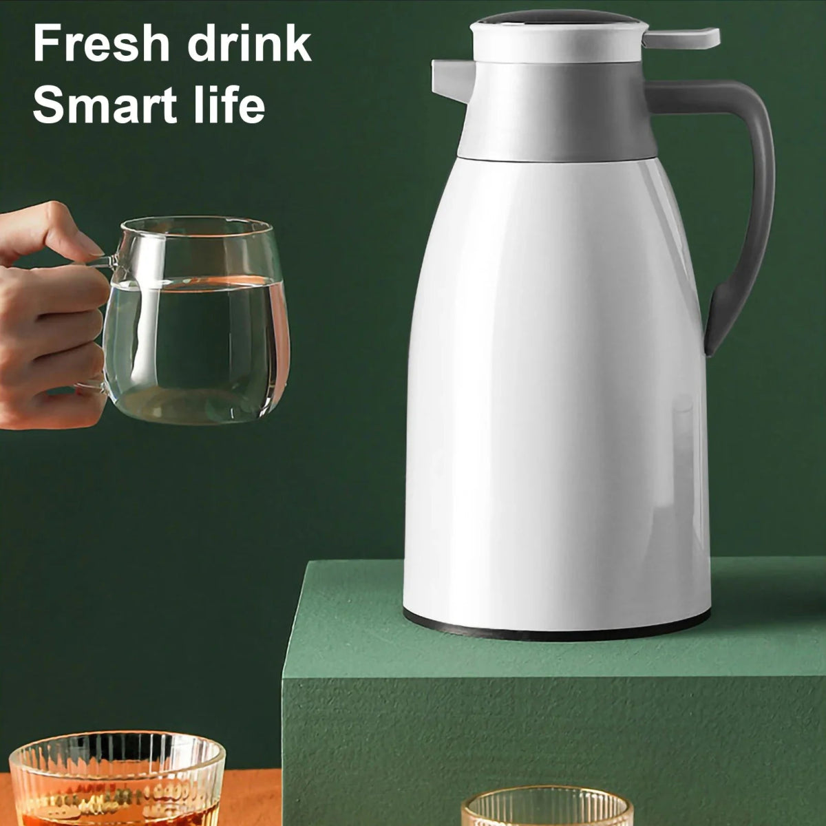 White thermos with a hand holding a glass of water on a green background