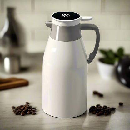 White thermos with digital temperature display on a kitchen counter with coffee beans.