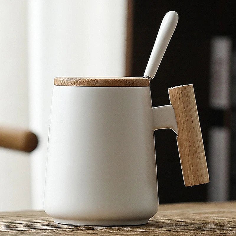White ceramic mug with wooden lid and handle on a wooden surface