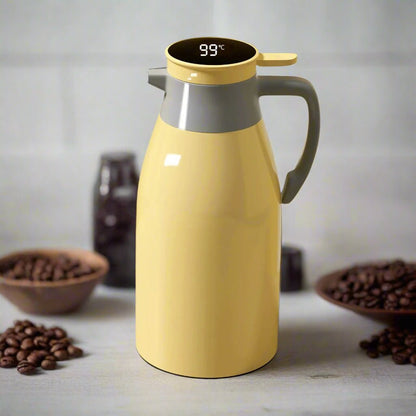 Yellow thermos with digital temperature display on a surface with coffee beans